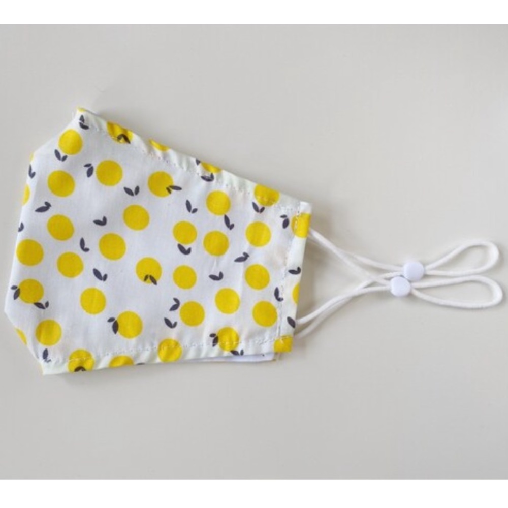 Citrus yellow polka dot face mask with adjustable straps in adult and child size